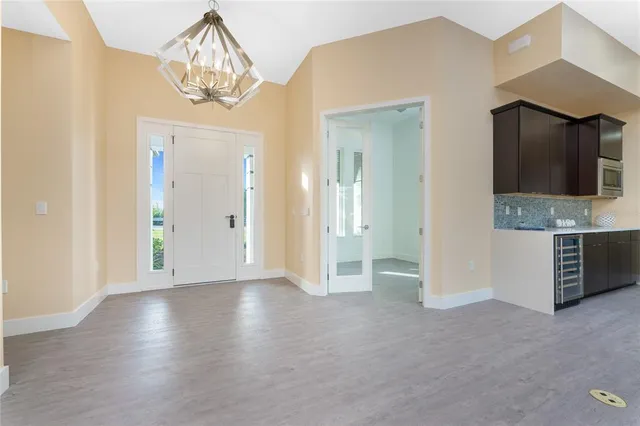 a view of a house with a big yard and potted plants