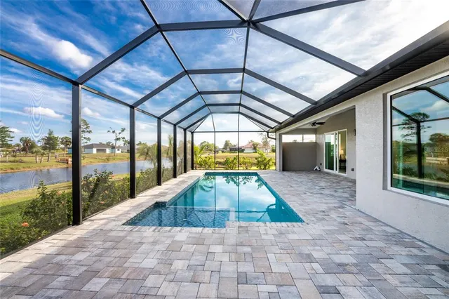 a view of a swimming pool with a yard