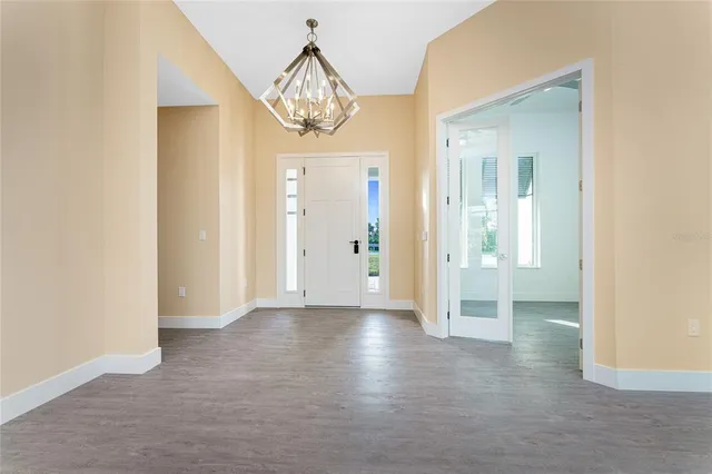 a view of a livingroom with wooden floor and a ceiling fan