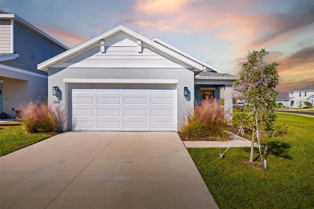 a front view of a house with a yard and garage