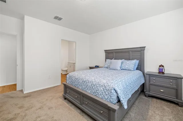 a bedroom with a bed and a dresser