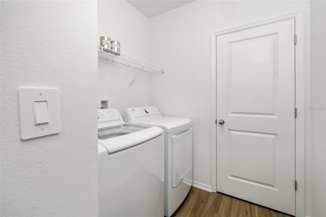 a view of an empty room with a birdcage and a window
