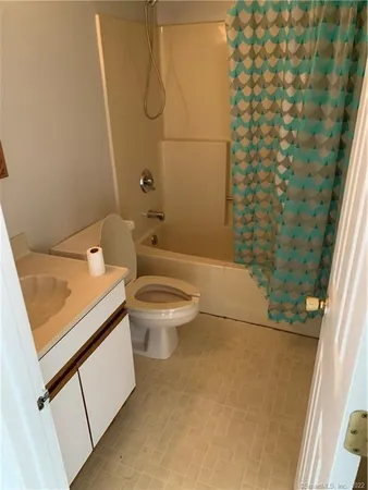 a bathroom with a toilet and shower