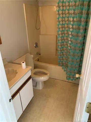 a bathroom with a toilet and shower