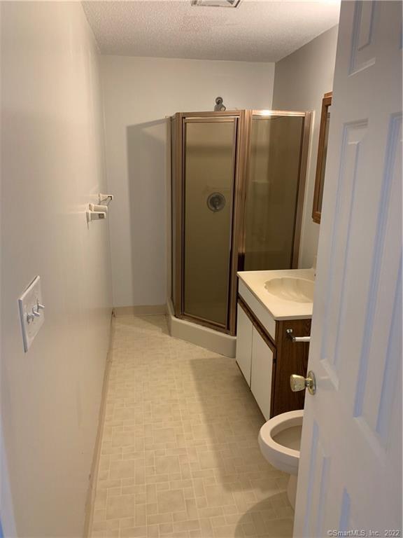 3250 East Main Street, Unit B209 Bridgeport, CT 06606 - Photo 10 of 16 a bathroom with a double vanity sink and mirror