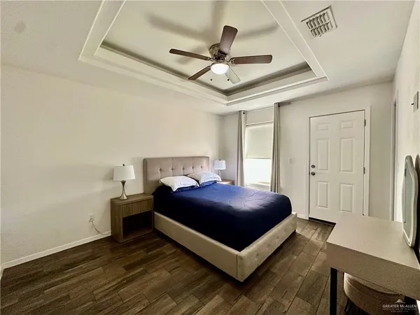 a bedroom with a bed and a ceiling fan