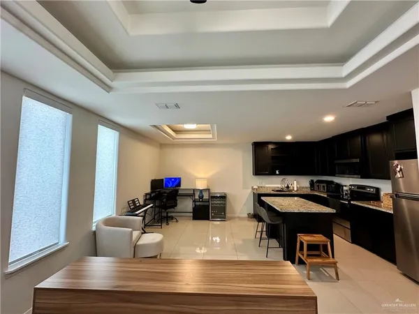 a living room with stainless steel appliances kitchen island furniture and a kitchen view