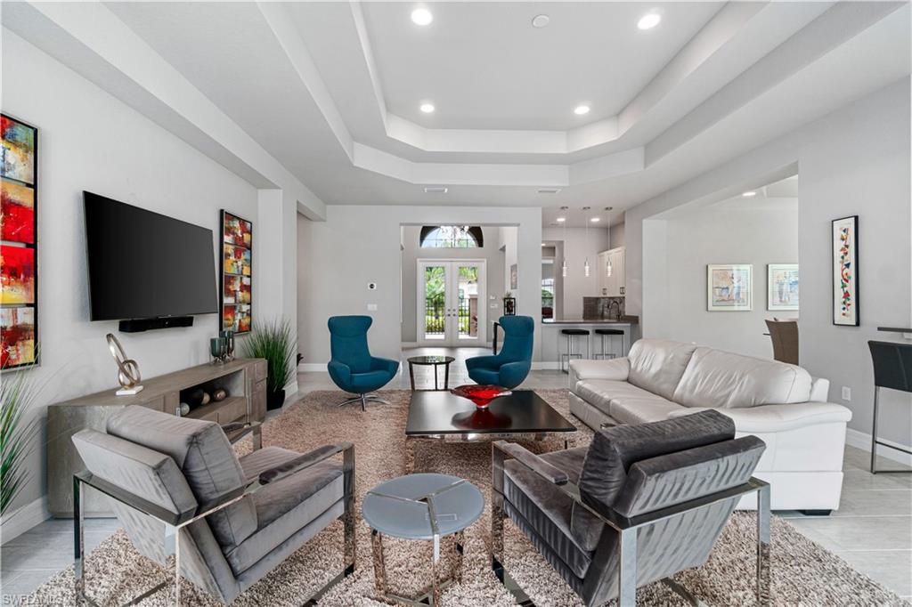 4427 Caldera Circle Naples, FL 34119 - Photo 11 of 50 a living room with furniture and a flat screen tv