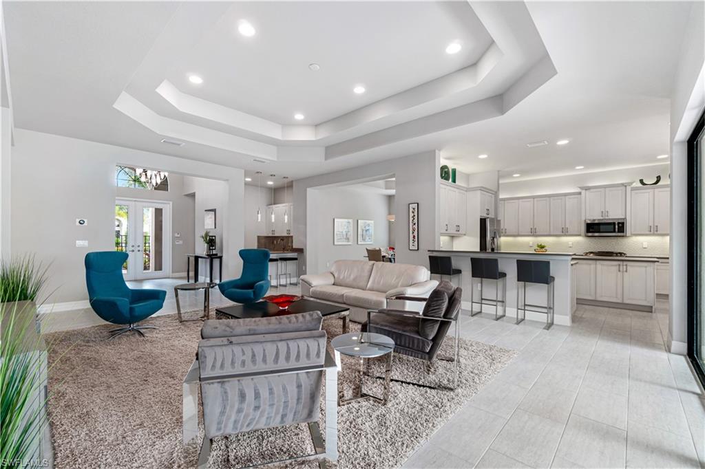4427 Caldera Circle Naples, FL 34119 - Photo 13 of 50 a living room with furniture and kitchen view