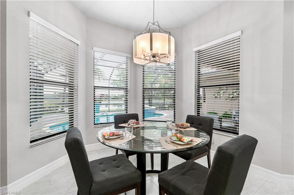 4427 Caldera Circle Naples, FL 34119 - Photo 17 of 50 a view of a dining room with furniture and windows