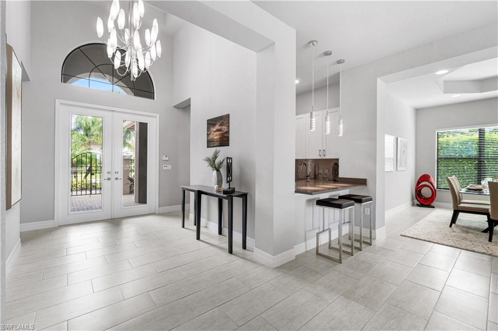4427 Caldera Circle Naples, FL 34119 - Photo 27 of 50 a view of a livingroom with furniture a dinning table and windows