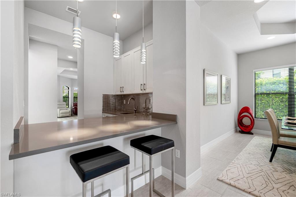 4427 Caldera Circle Naples, FL 34119 - Photo 28 of 50 a view of kitchen island with furniture and living room