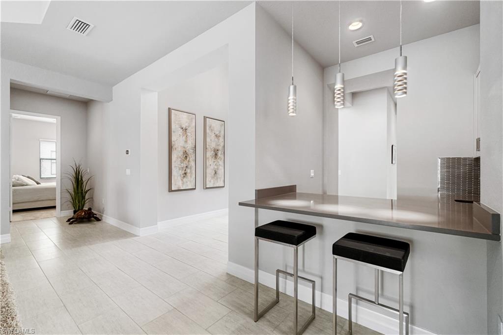 4427 Caldera Circle Naples, FL 34119 - Photo 30 of 50 a room with a table chairs and entryway