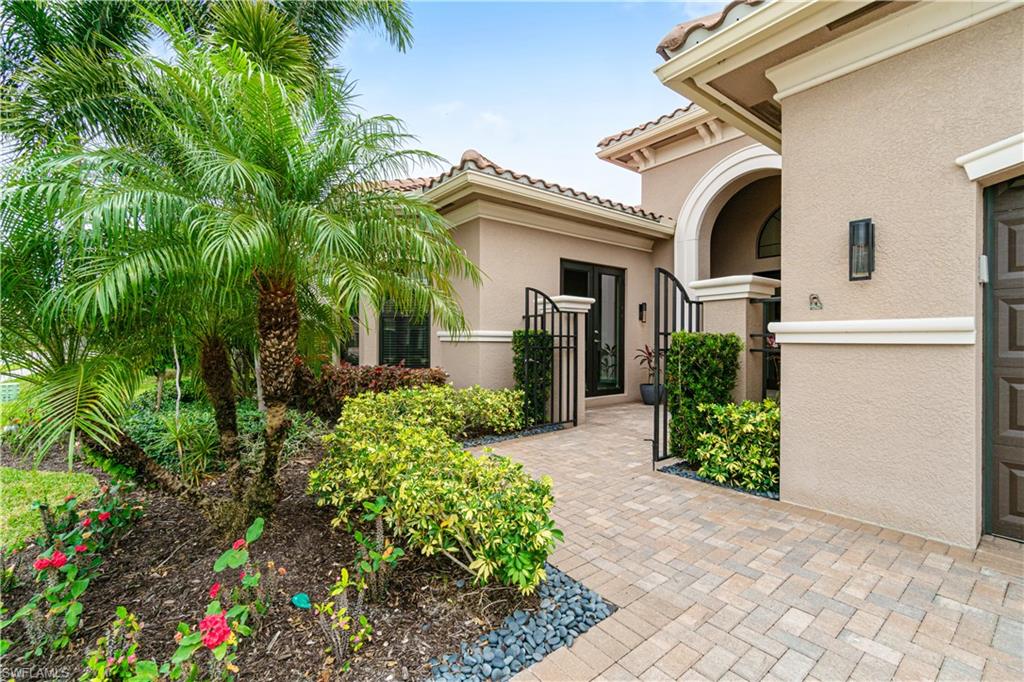 4427 Caldera Circle Naples, FL 34119 - Photo 3 of 50 a front view of a house with garden