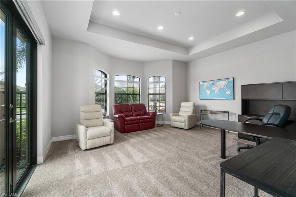4427 Caldera Circle Naples, FL 34119 - Photo 32 of 50 a living room with furniture and a flat screen tv