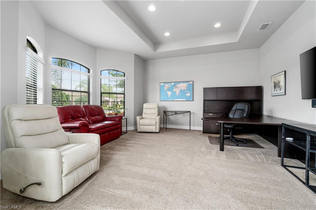4427 Caldera Circle Naples, FL 34119 - Photo 33 of 50 a living room with furniture and a gym machine next to a window