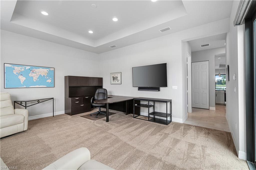 4427 Caldera Circle Naples, FL 34119 - Photo 34 of 50 a living room with furniture and a flat screen tv