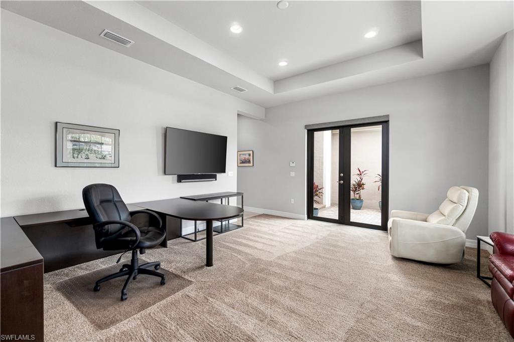 4427 Caldera Circle Naples, FL 34119 - Photo 35 of 50 a living room with furniture and a flat screen tv