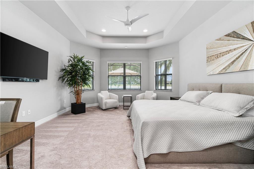 4427 Caldera Circle Naples, FL 34119 - Photo 37 of 50 a bed room with a bed a television and a large window