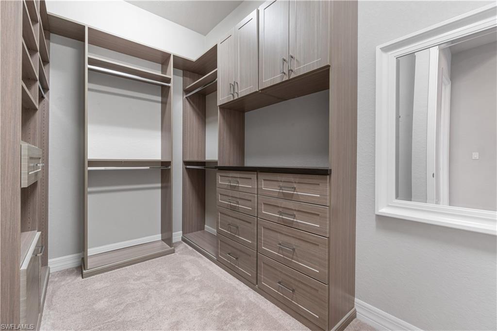 4427 Caldera Circle Naples, FL 34119 - Photo 41 of 50 a view of walk in closet with empty racks