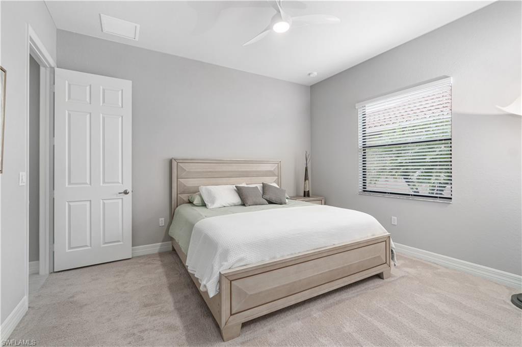4427 Caldera Circle Naples, FL 34119 - Photo 42 of 50 a bed sitting in a bedroom next to a window