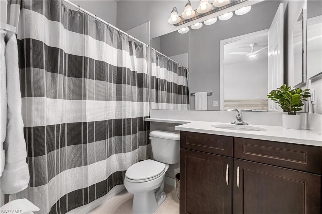 4427 Caldera Circle Naples, FL 34119 - Photo 44 of 50 a bathroom with a sink a toilet a shower and a mirror