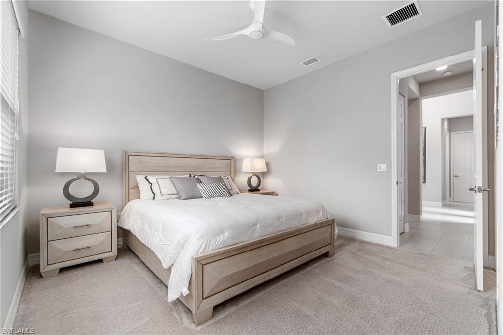 4427 Caldera Circle Naples, FL 34119 - Photo 46 of 50 a bedroom with a bed and a lamp