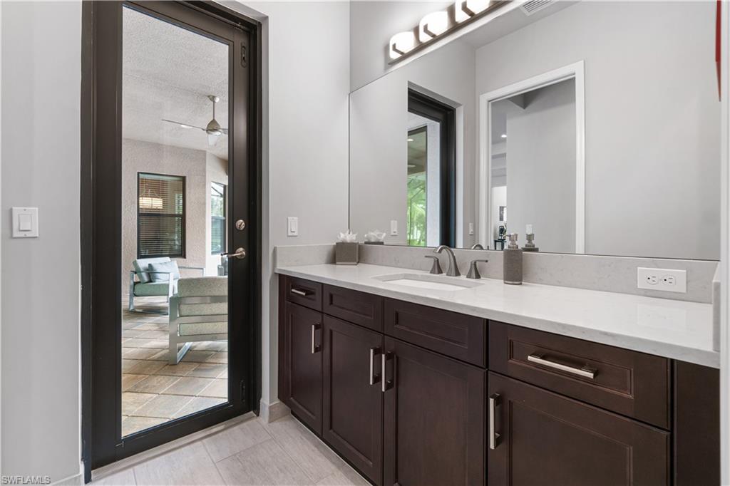 4427 Caldera Circle Naples, FL 34119 - Photo 48 of 50 a bathroom with a sink and a mirror