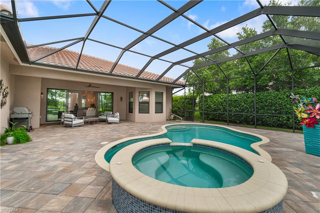 4427 Caldera Circle Naples, FL 34119 - Photo 49 of 50 a swimming pool with outdoor seating yard and green space