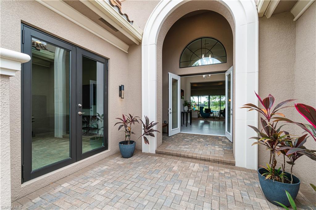 4427 Caldera Circle Naples, FL 34119 - Photo 5 of 50 a front view of a house with porch