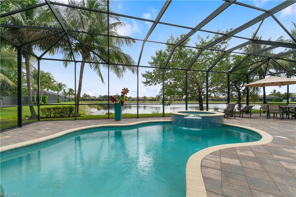 4427 Caldera Circle Naples, FL 34119 - Photo 7 of 50 a view of a swimming pool with a patio