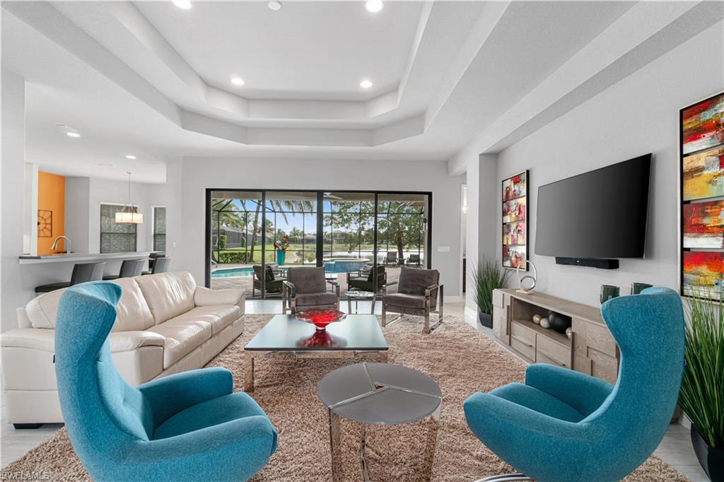 4427 Caldera Circle Naples, FL 34119 - Photo 9 of 50 a living room with furniture and a flat screen tv