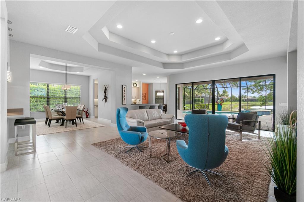 4427 Caldera Circle Naples, FL 34119 - Photo 10 of 50 a living room with furniture a lamp and a potted plant