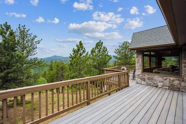 a view of balcony with furniture and wooden deck