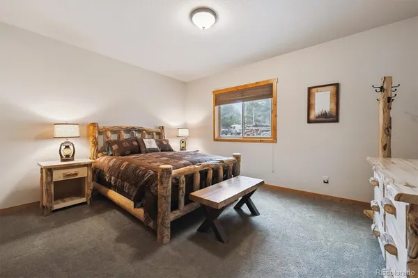 a bedroom with a bed and a desk