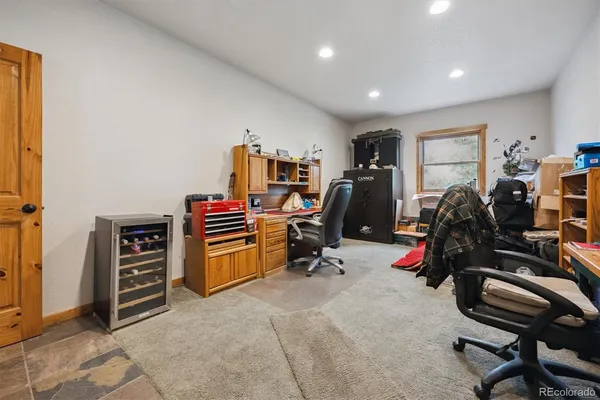 a view of a workspace with furniture and gym equipment