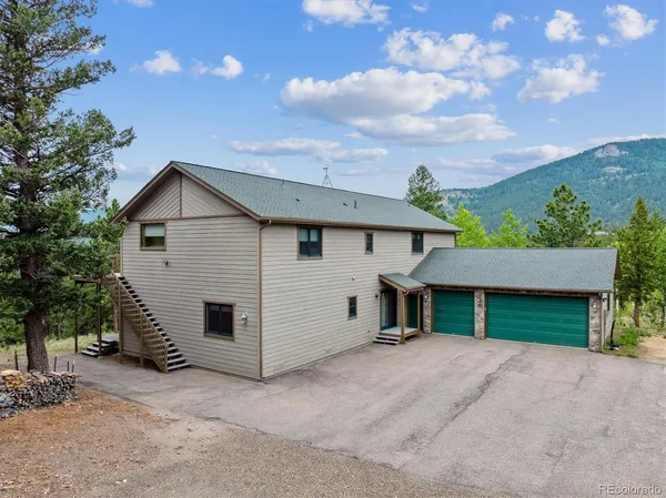 a view of a house with a yard and garage