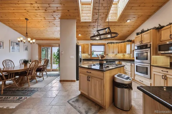 a kitchen with stainless steel appliances granite countertop a stove and refrigerator