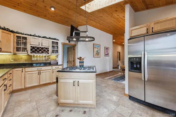 a kitchen with stainless steel appliances granite countertop a sink and cabinets