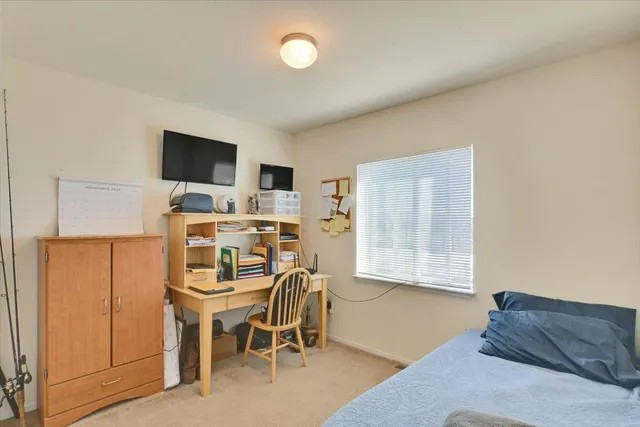 a dining room with furniture and a flat screen tv