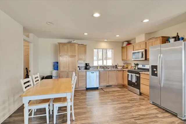 a large kitchen with a table and chairs