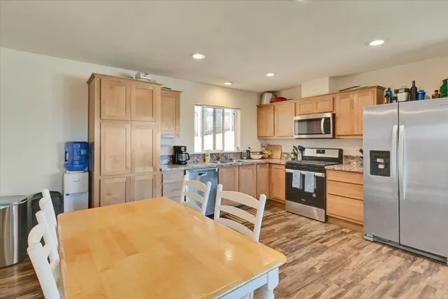 a kitchen with stainless steel appliances a refrigerator stove microwave and a refrigerator