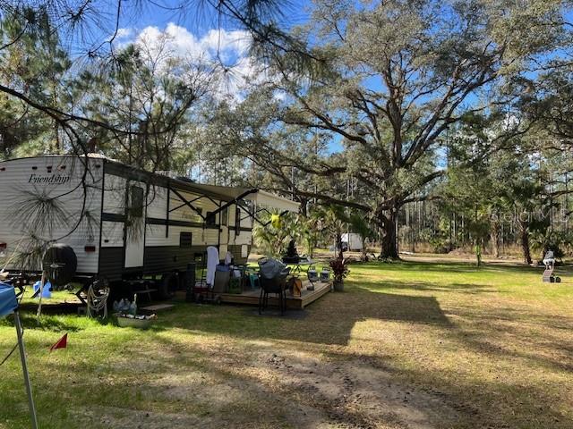 9600 Northeast 90th Street Road Fort McCoy, FL 32134 - Photo 29 of 32 a view of yard with swimming pool and trees