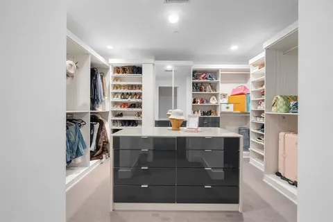 a room with a cabinets and a bookshelf