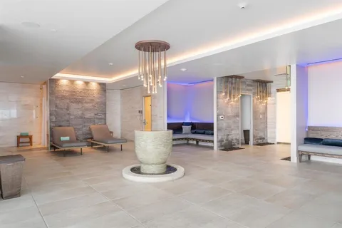 a very nice looking room with a large window and furniture