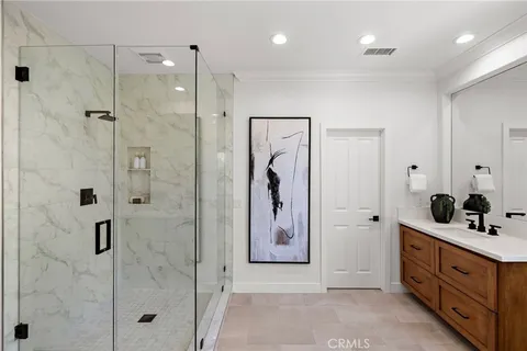 a bathroom with a double vanity sink shower and a mirror