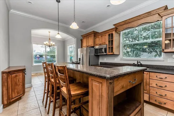 a kitchen with stainless steel appliances a sink a stove and a microwave