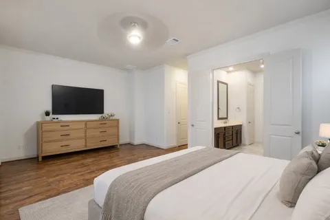a bedroom with a bed and a flat screen tv