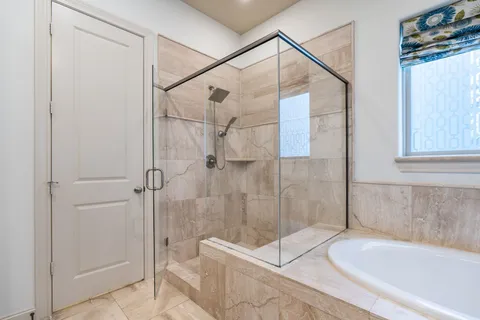 a bathroom with a shower and bathtub