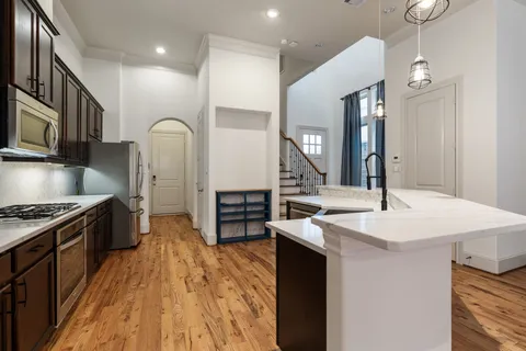 a kitchen with stainless steel appliances granite countertop a sink stove and refrigerator
